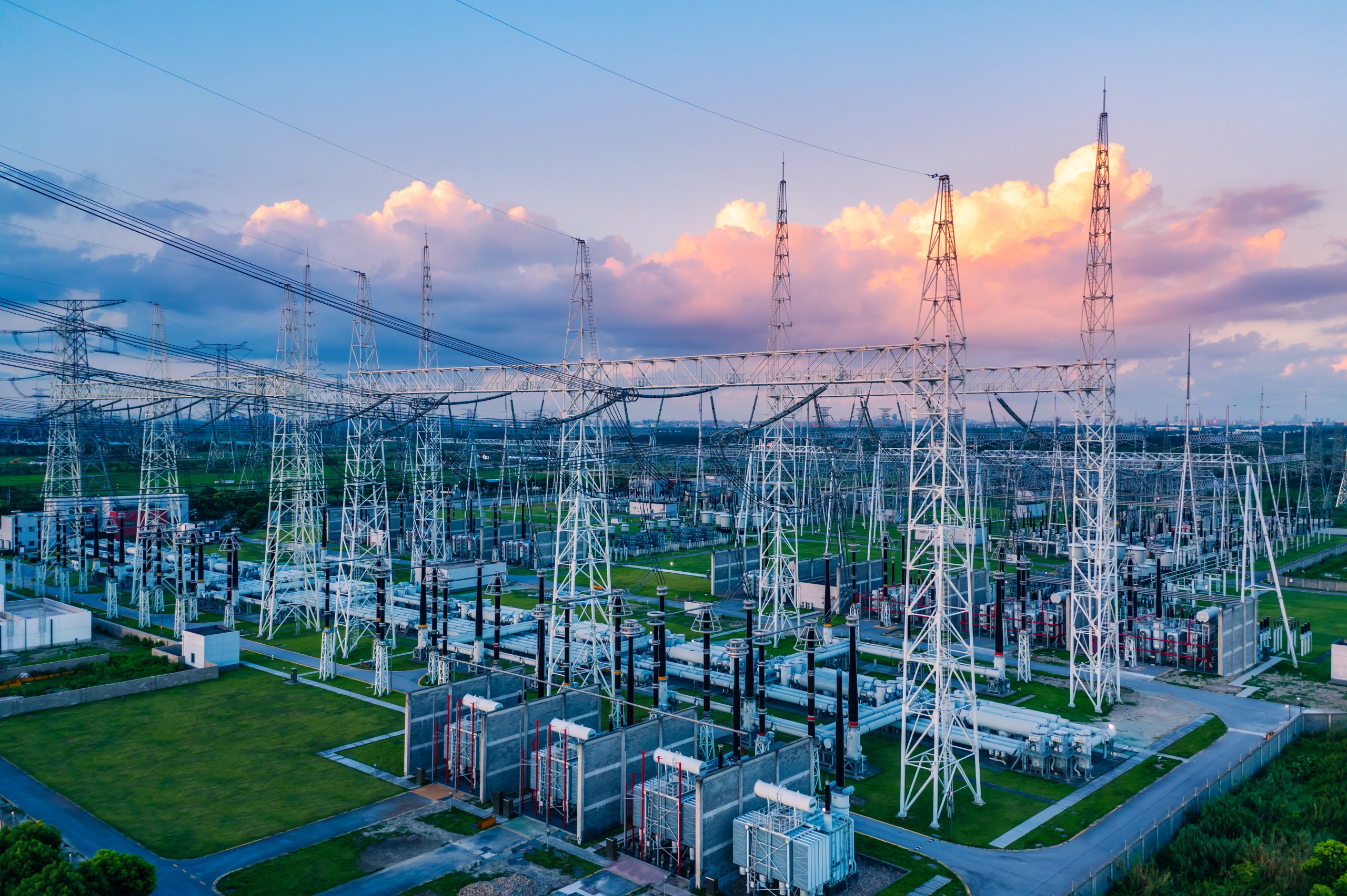 Electrical substation equipment and power infrastructure at sunset